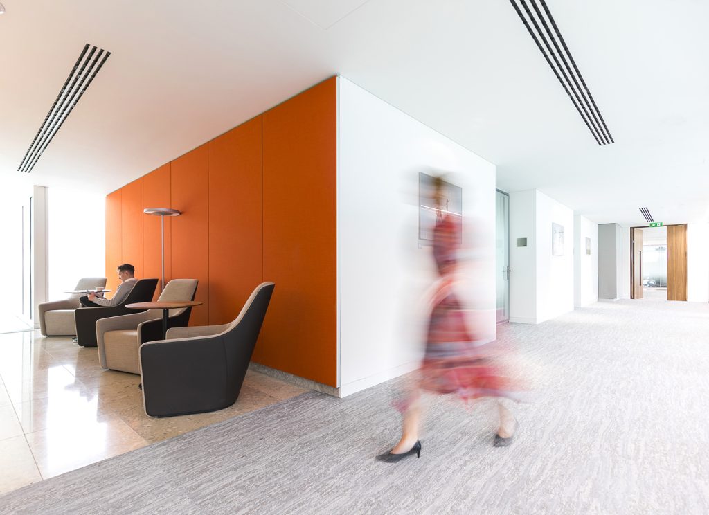 orange wall, corridor, person walking