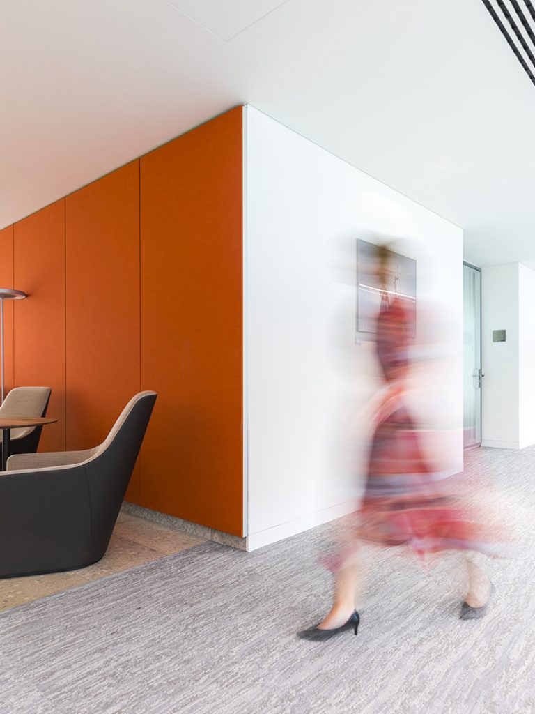 orange wall, corridor, person walking