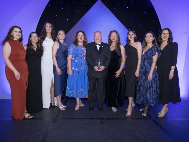 Picture of named people below at the 2023 Chambers Ireland Sustainable Business Impact Awards. Male in the middle hols the award.