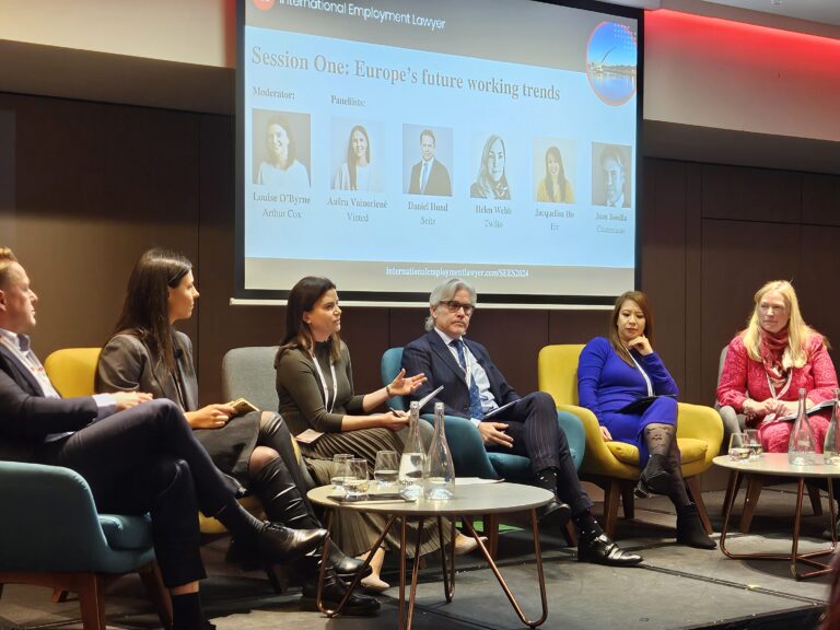 A panel of six people at a conference.